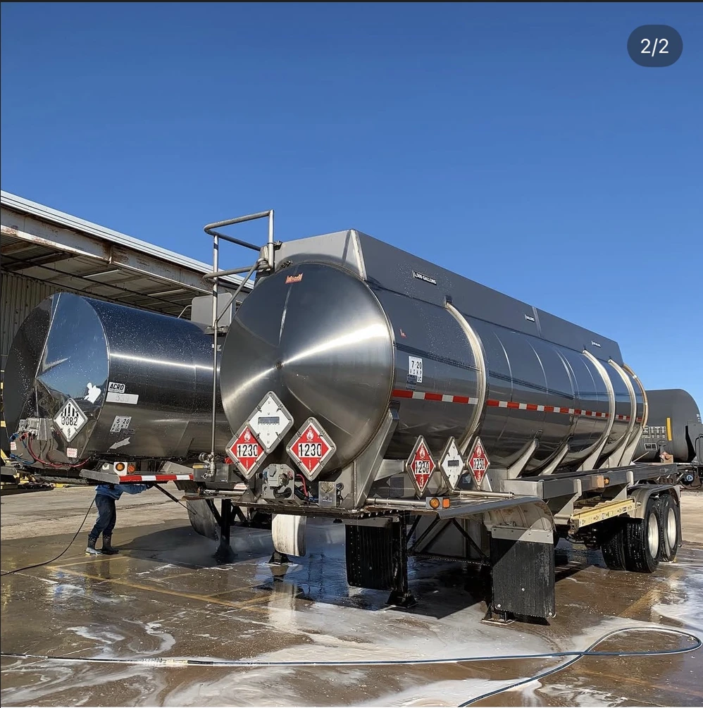 After washing: the same tanker trailer with a clean, reflective tank and washed frame and wheels.